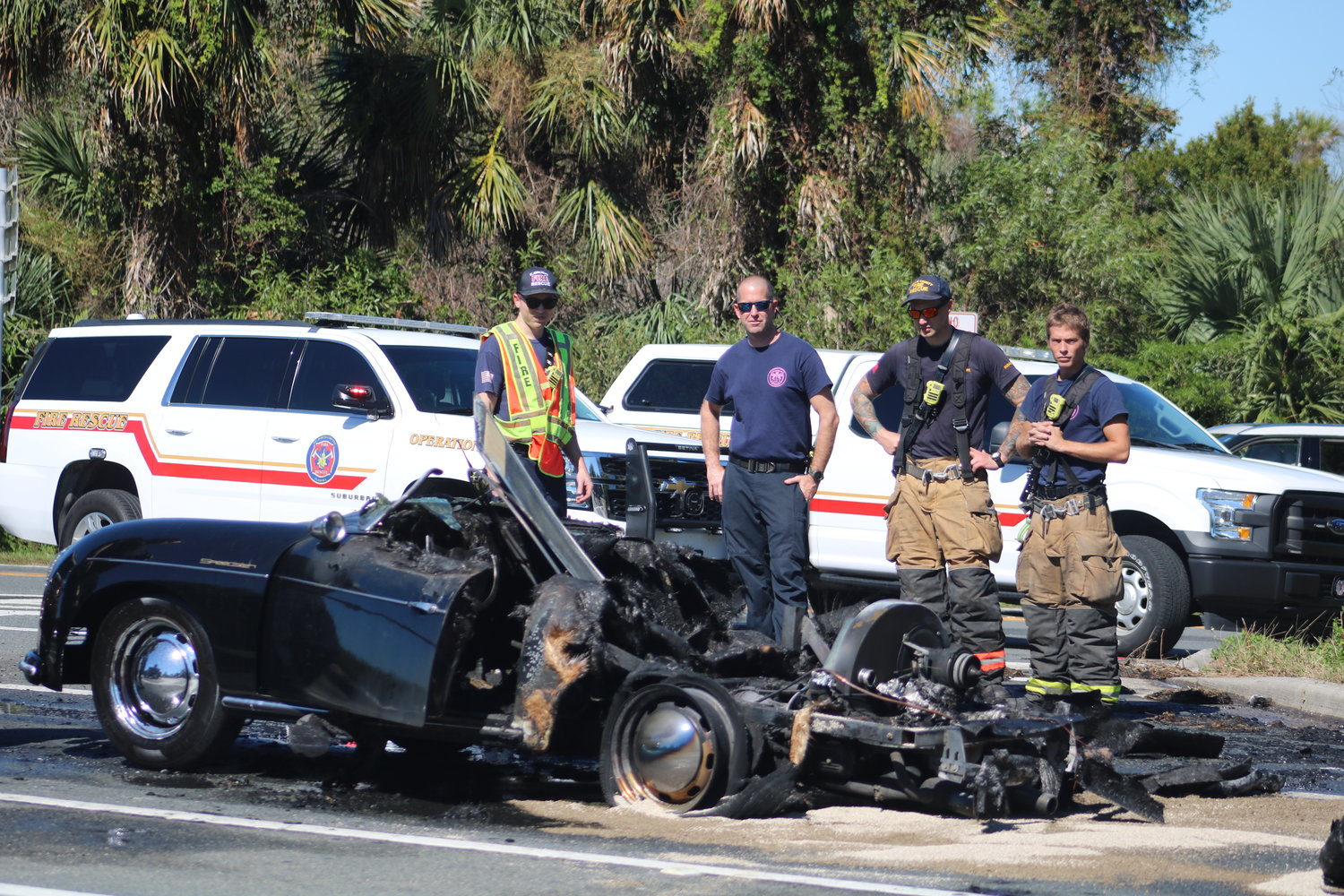 Members of St. Johns County Fire Rescue Station 10 look on after extinguishing a car fire near the intersection of A1A and Mickler Road Oct. 26.
